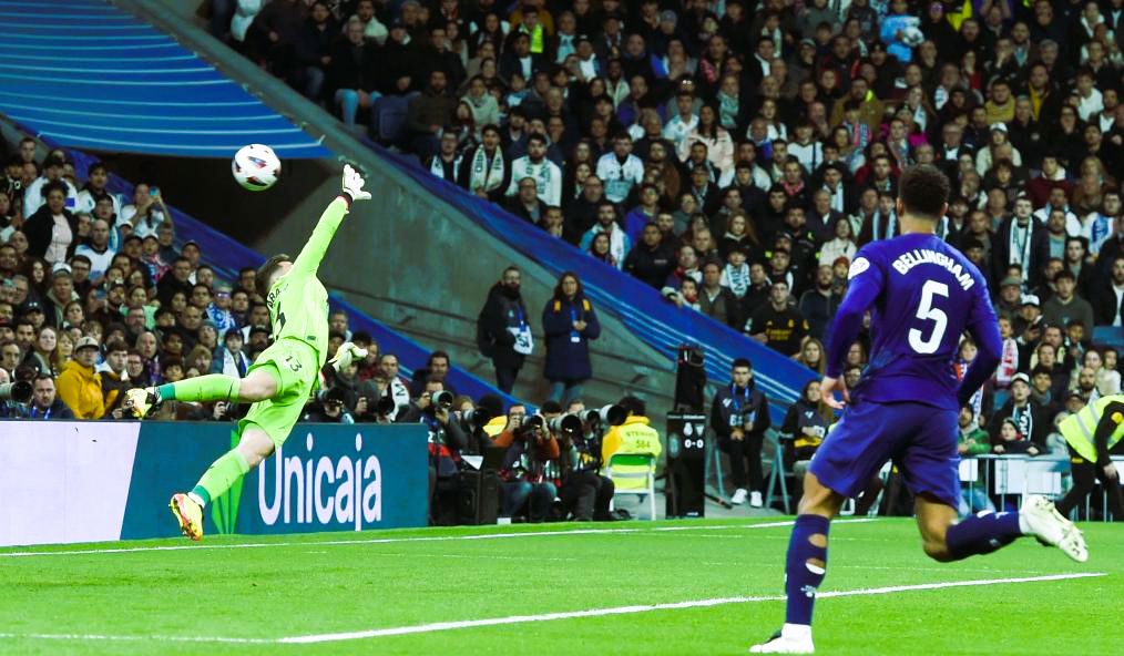 Real Madrid's Jude Bellingham vies with Athletic Club's Mikel Vesga during the La Liga football match between Real Madrid